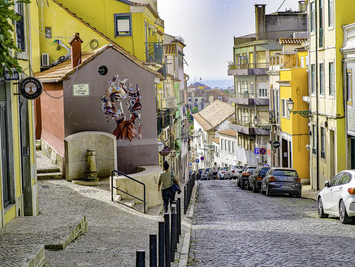 Charming Lisbon historic quarter street with traditional buildings where local artisans sell handmade crafts