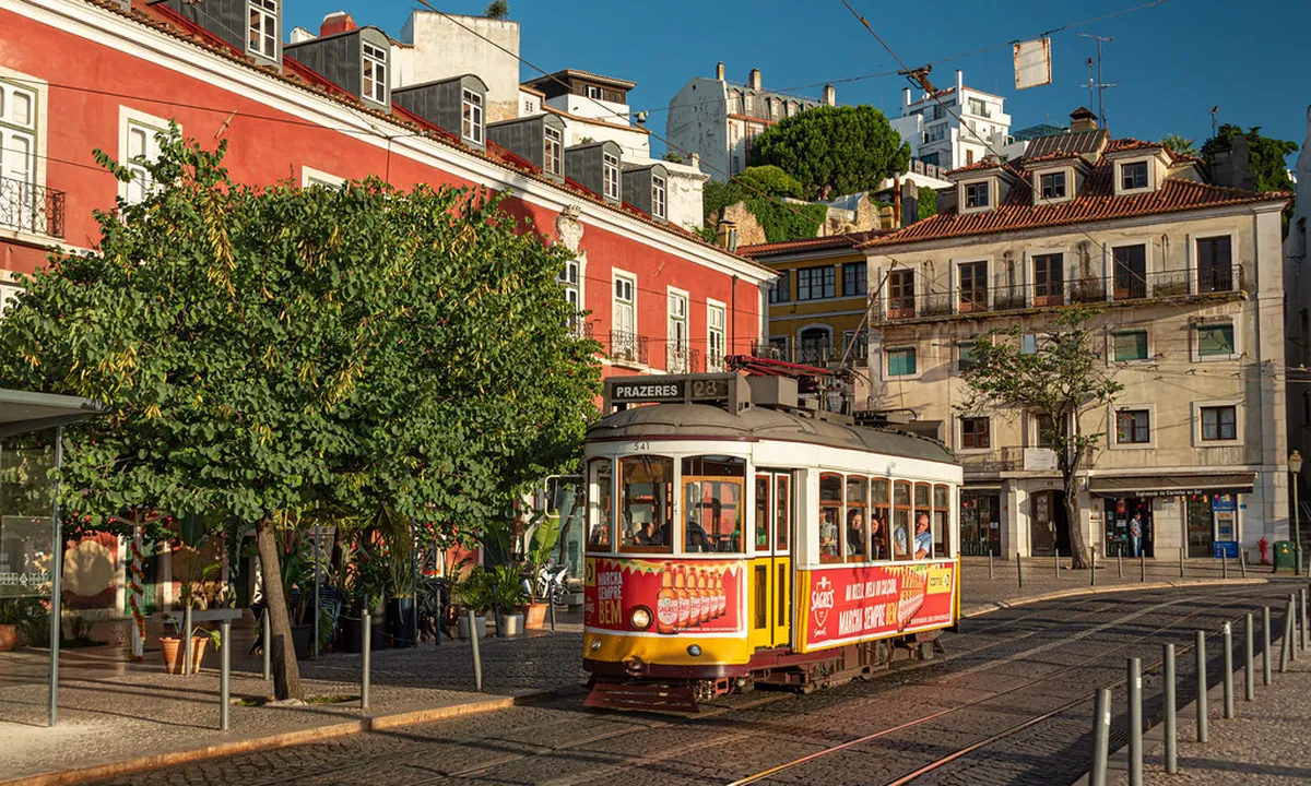 Lisbon's narrow Alfama streets bathed in soft early morning light before Tram 28 crowds arrive