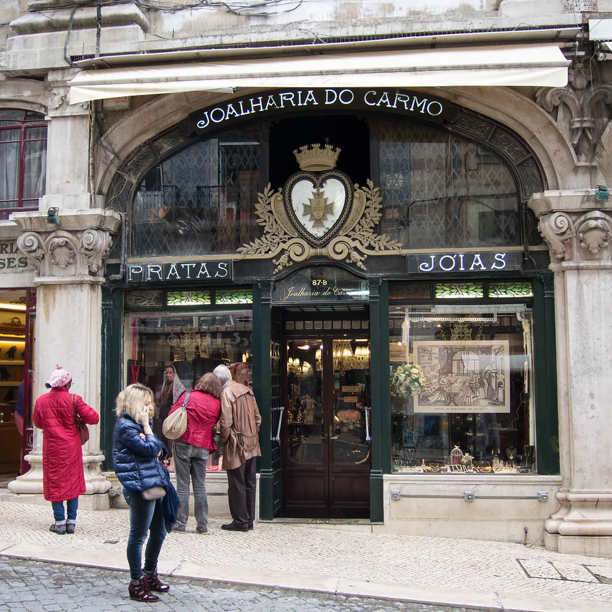 Lisbon Chiado shopping street lined with stylish boutiques and colourful buildings