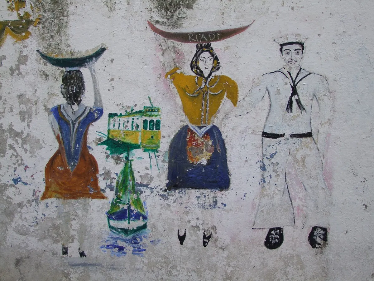 Lisbon street art tour guide leading visitors through a narrow alley lined with painted murals
