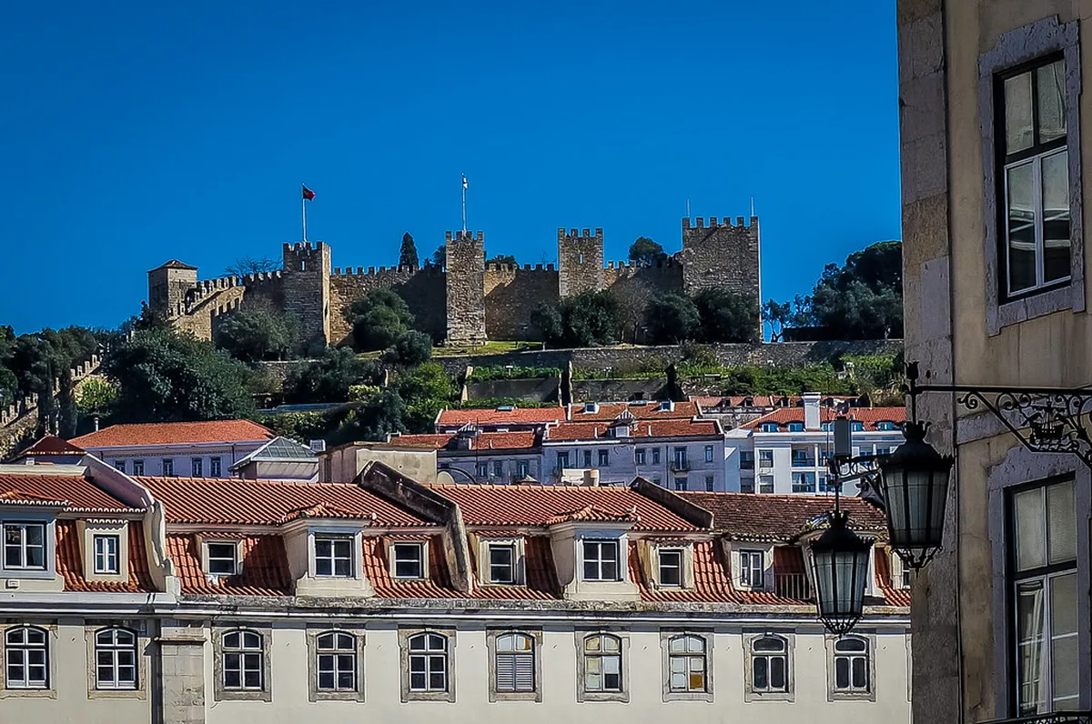 Sweeping panoramic view of Lisbon rooftops and the Tagus river from the battlements of Castelo de São Jorge