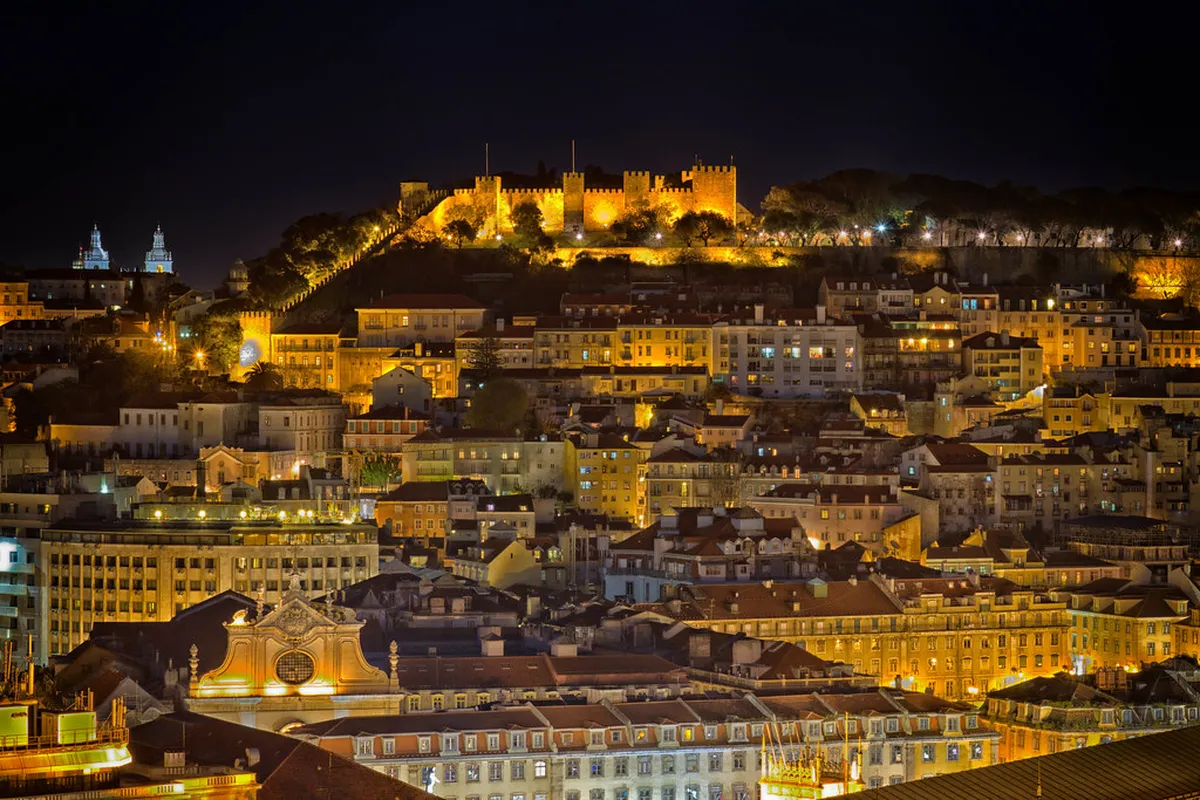 Castelo de São Jorge walls and Moorish defensive towers rising above Lisbon's hilltop citadel