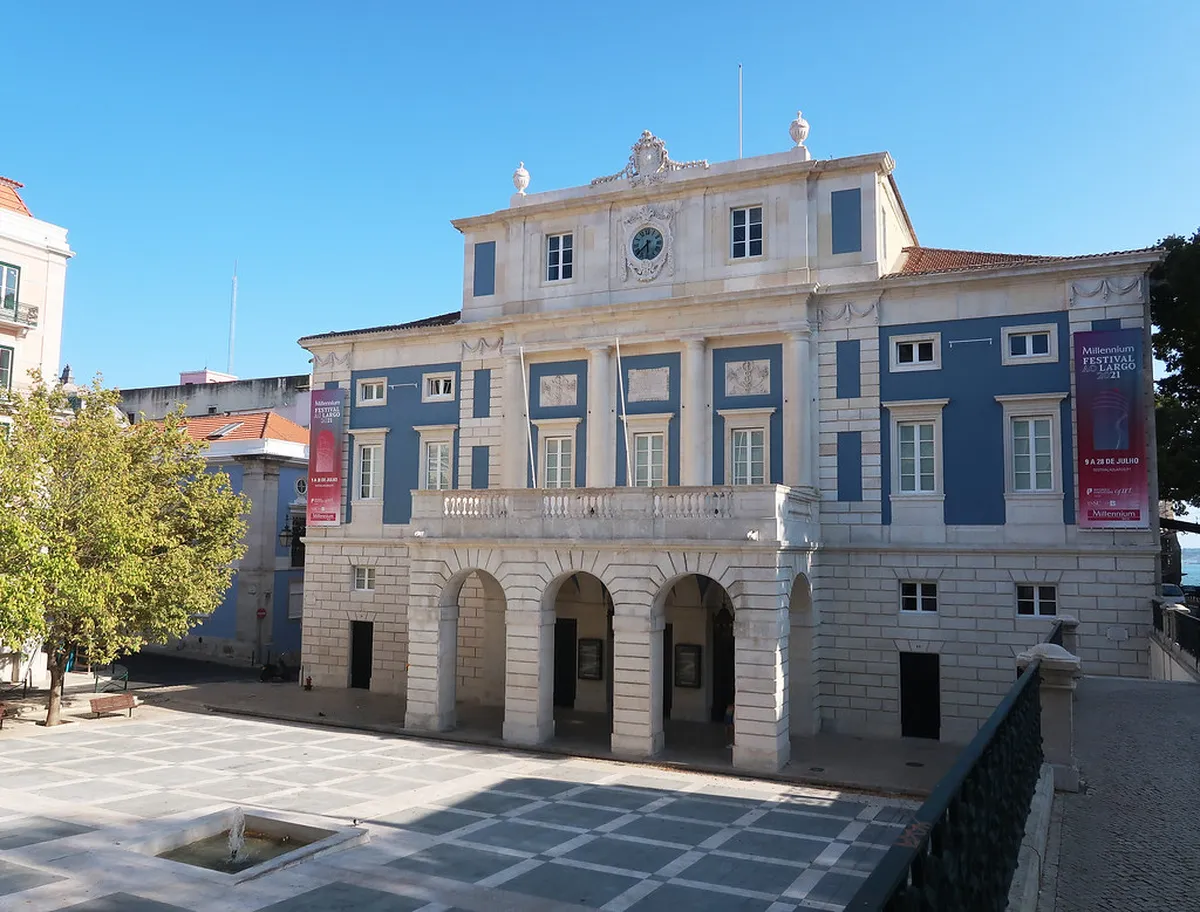 A classic Lisbon theatre facade in Chiado with ornate architectural details and evening lighting