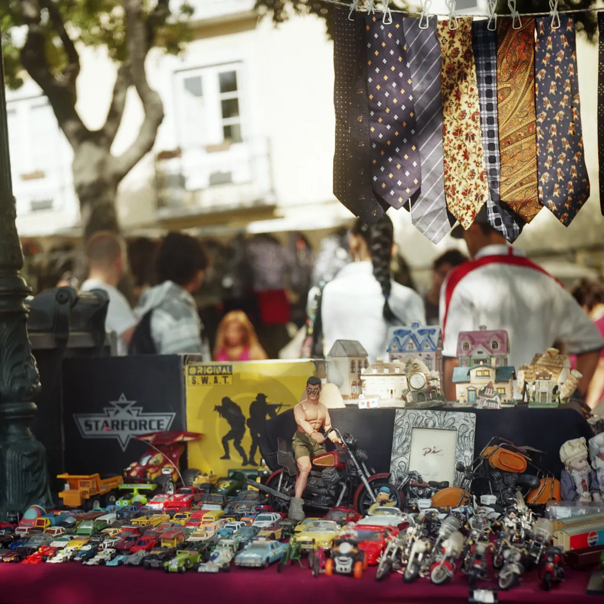 Colourful market stalls packed with vintage goods and antiques at Lisbon's Feira da Ladra flea market
