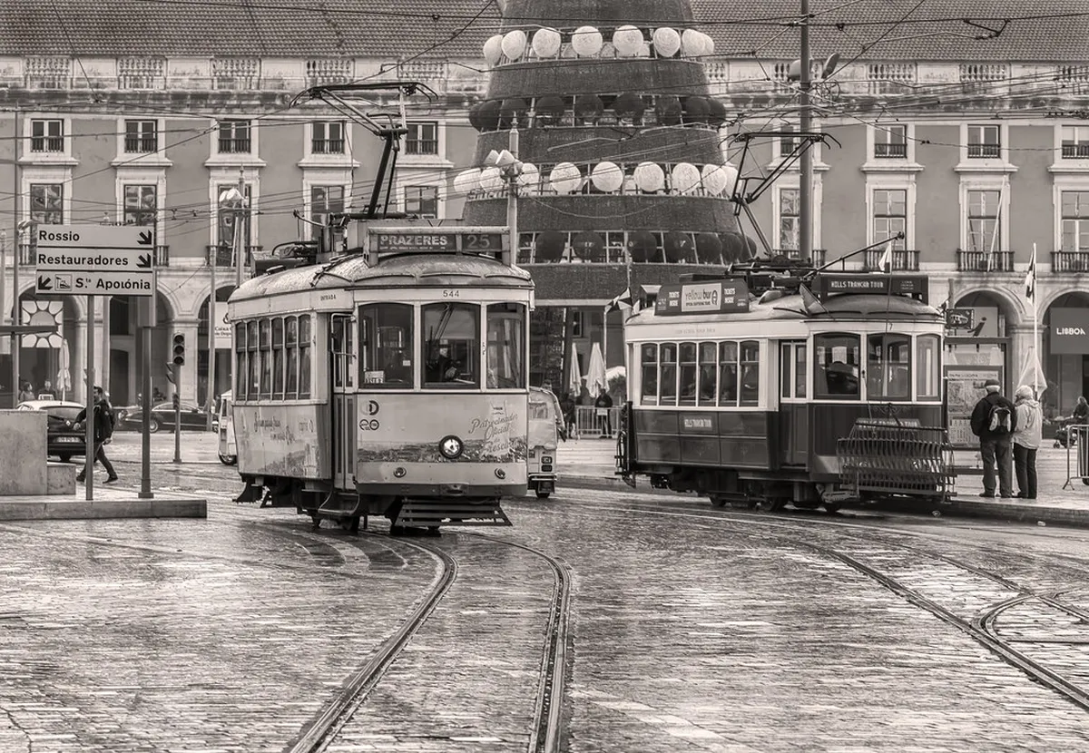 Lisbon tram passing through Praça do Comércio on the way to Belém, with the riverside waterfront in the background