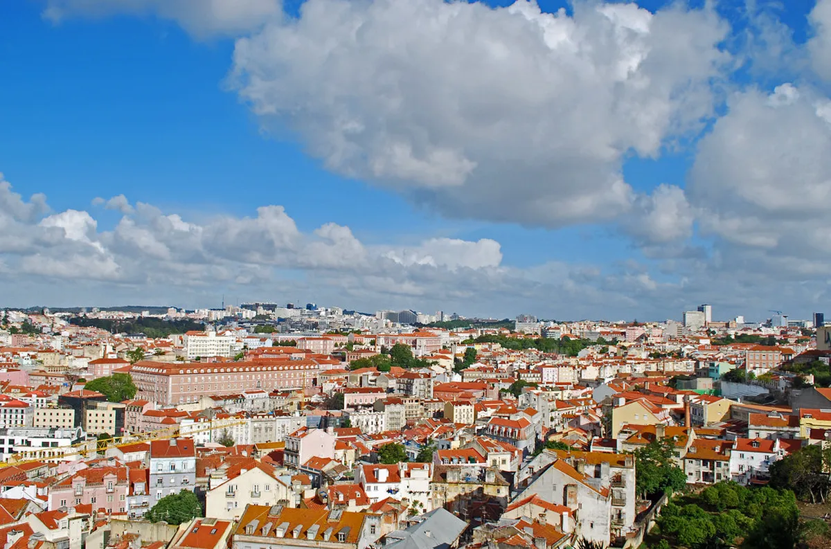 Miradouro da Graça terrace in Lisbon overlooking the Alfama district and São Jorge Castle with warm evening light
