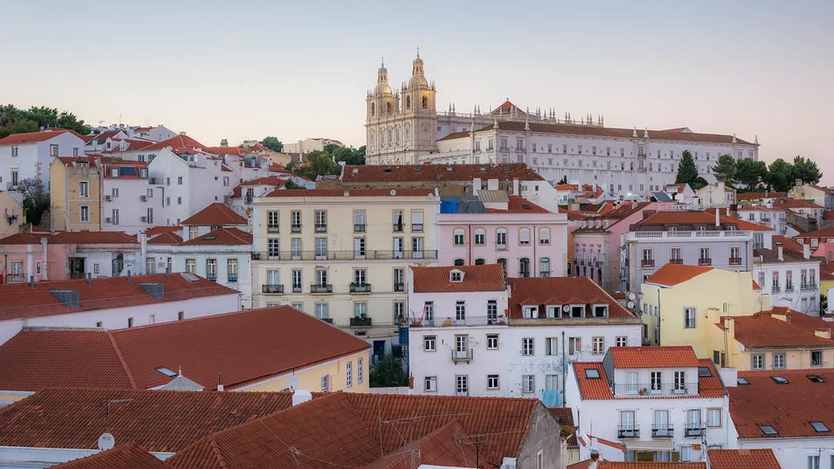 Mosteiro de São Vicente de Fora Lisbon with its white baroque facade overlooking the Alfama rooftops