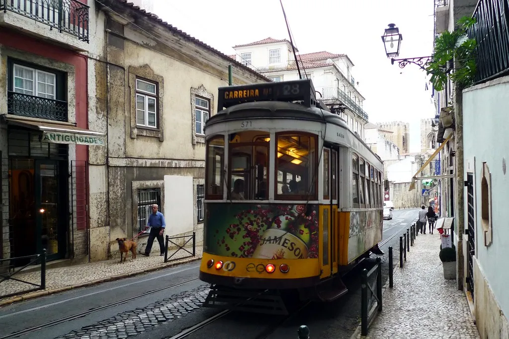 Lisbon tram 28 climbing the steep Alfama hillside along its scenic route through the old city