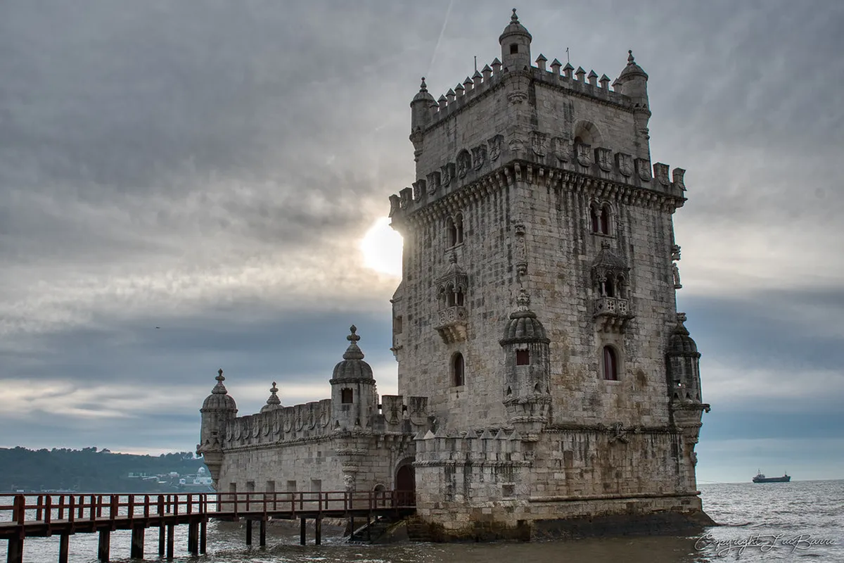 Belém Tower rising beside the Tagus River in Lisbon, showcasing ornate Manueline architecture at golden hour