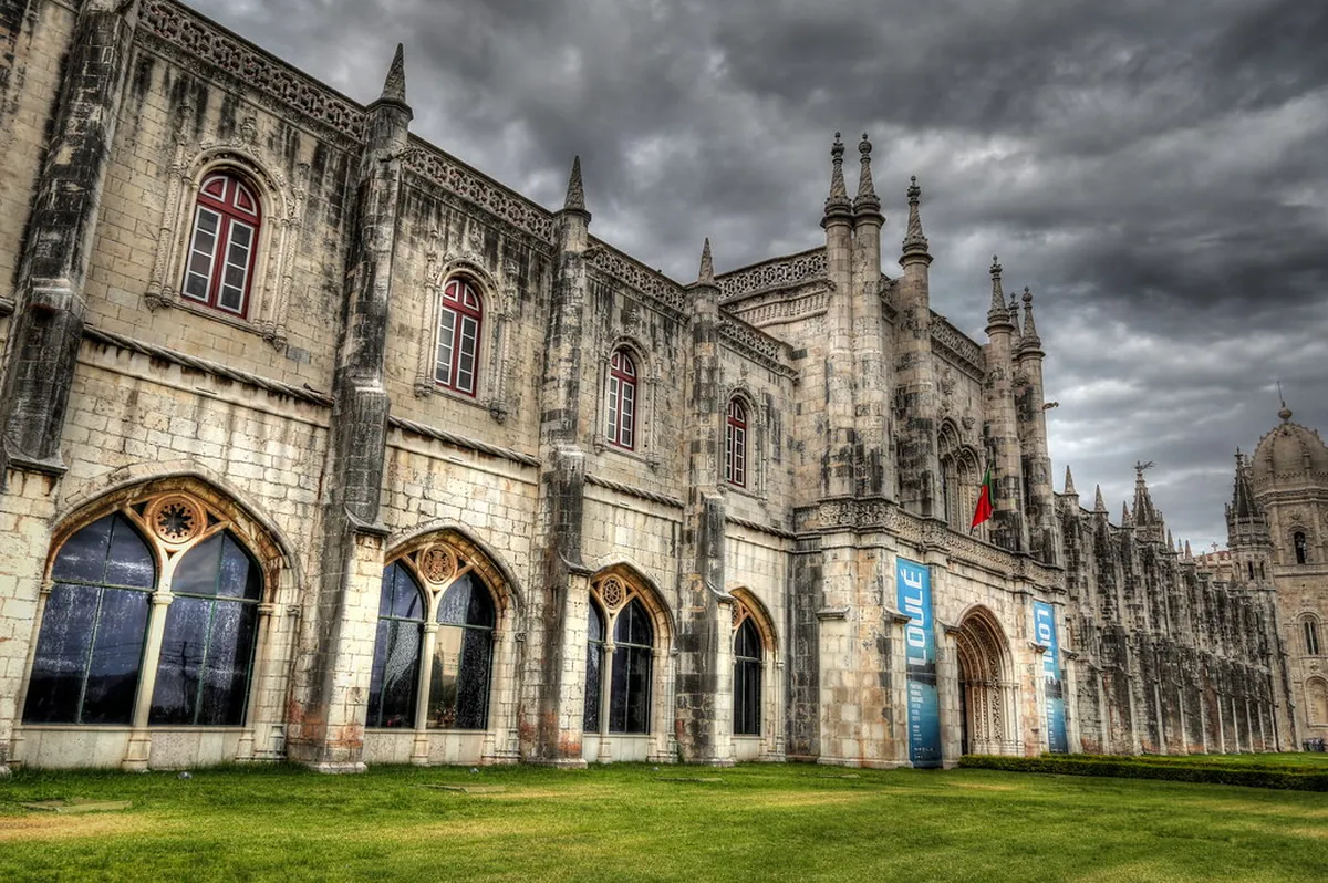 Ornate Manueline cloister arches inside Lisbon's Jerónimos Monastery bathed in soft natural light