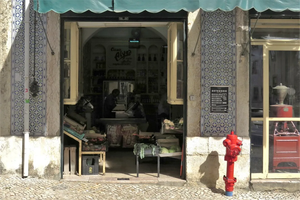 Colourful tiled facades lining a historic Lisbon neighbourhood street, ideal for self-guided heritage walks