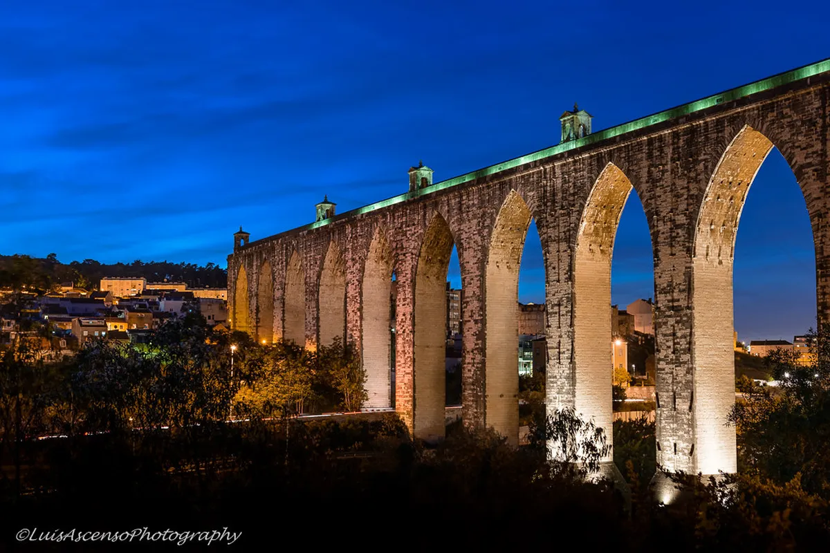 Lisbon's Aqueduto das Águas Livres arches rising over the Alcântara Valley, a stunning 18th-century engineering landmark