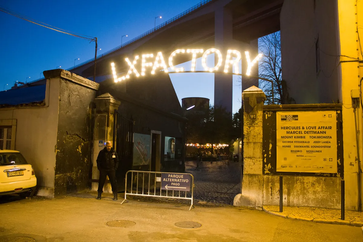 Lisbon LX Factory Sunday market with shoppers browsing vintage and artisanal goods in a creative industrial setting