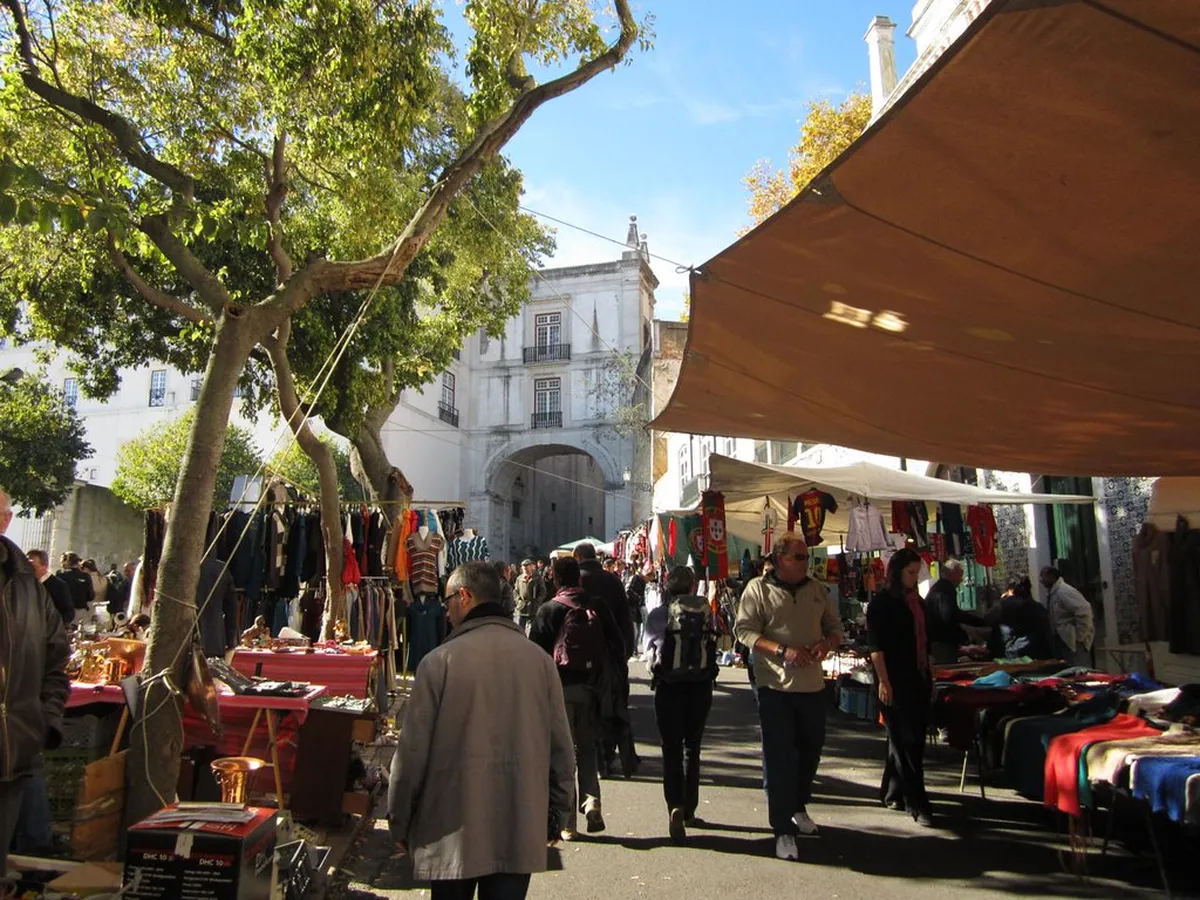 Lisbon Feira da Ladra open-air flea market with vendors selling antiques and collectibles