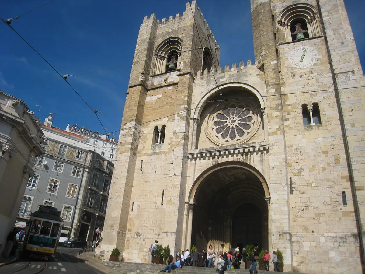 Lisbon Cathedral Sé façade with twin Romanesque bell towers rising above the historic city