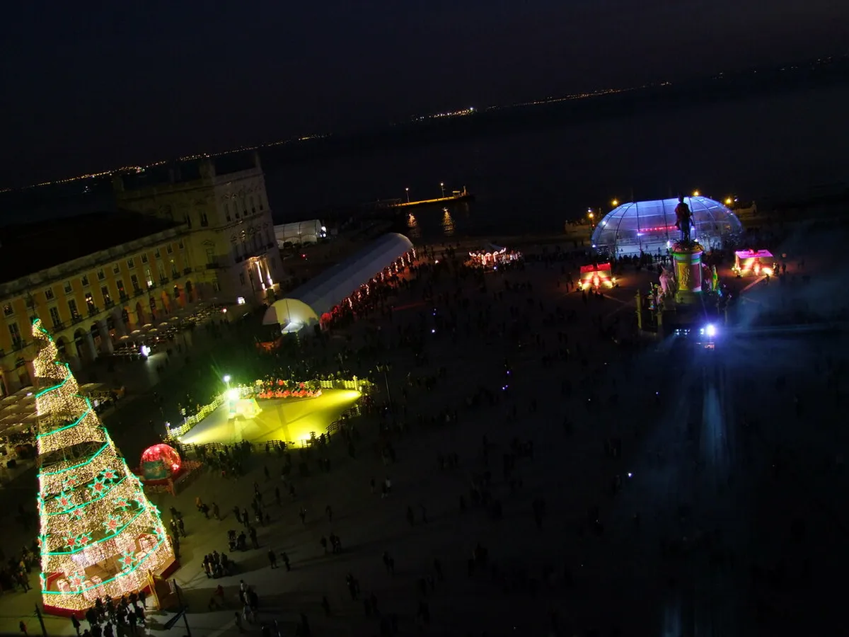 Lisbon Praça do Comércio illuminated with Christmas lights and festive decorations framing the triumphal arch
