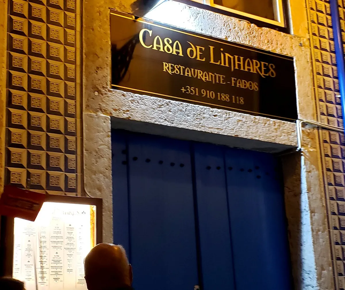 Lisbon Fado dinner setting inside a traditional Portuguese restaurant with warm candlelit ambiance and intimate dining atmosphere