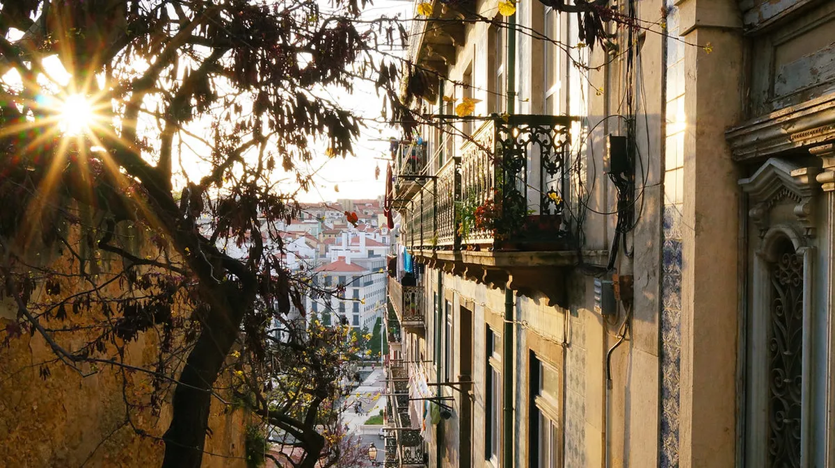 Lisbon Mouraria historic neighbourhood colourful street with traditional azulejo tiles and authentic residential patio