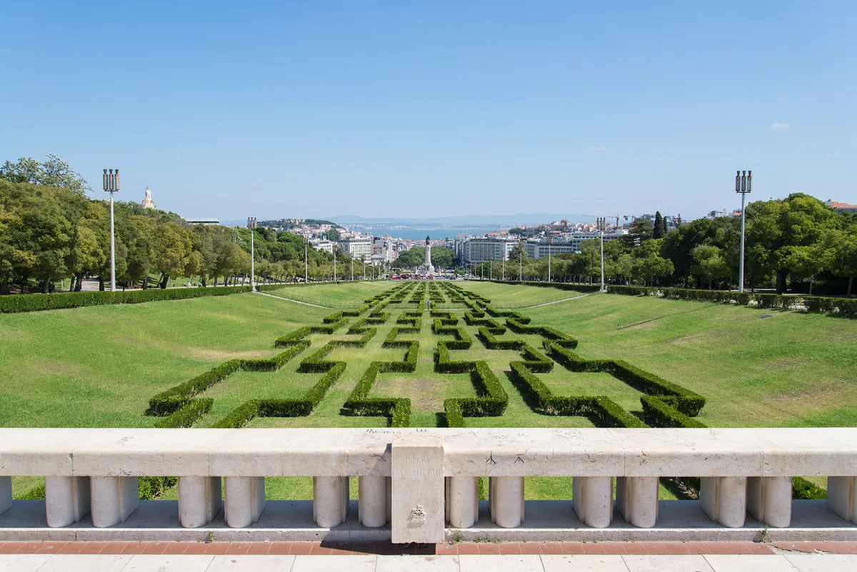 Parque Eduardo VII in Lisbon stretching toward the Tagus River with geometric green lawns and city panorama