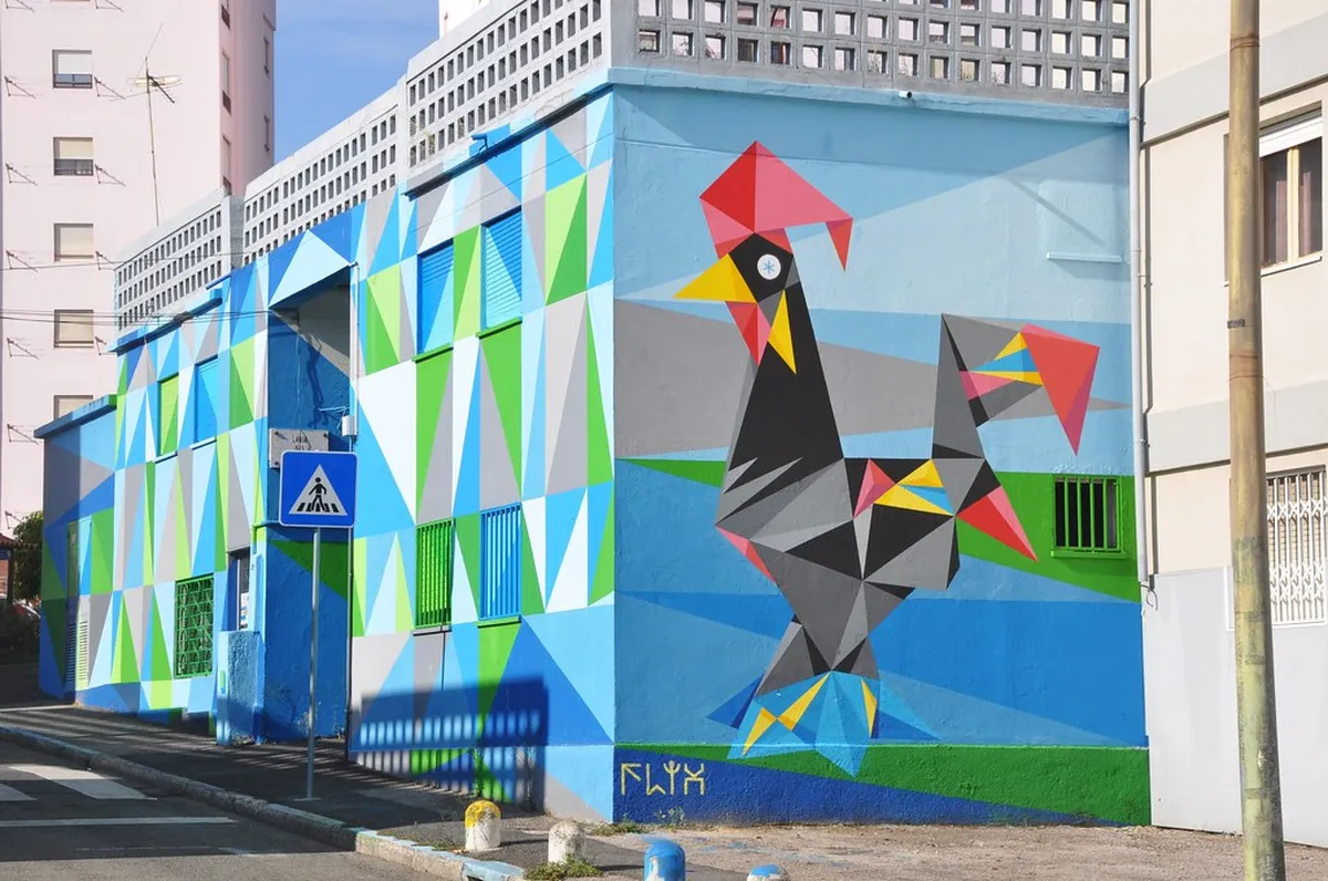 Large-scale Lisbon street mural covering a building wall in the Marvila neighborhood during daytime