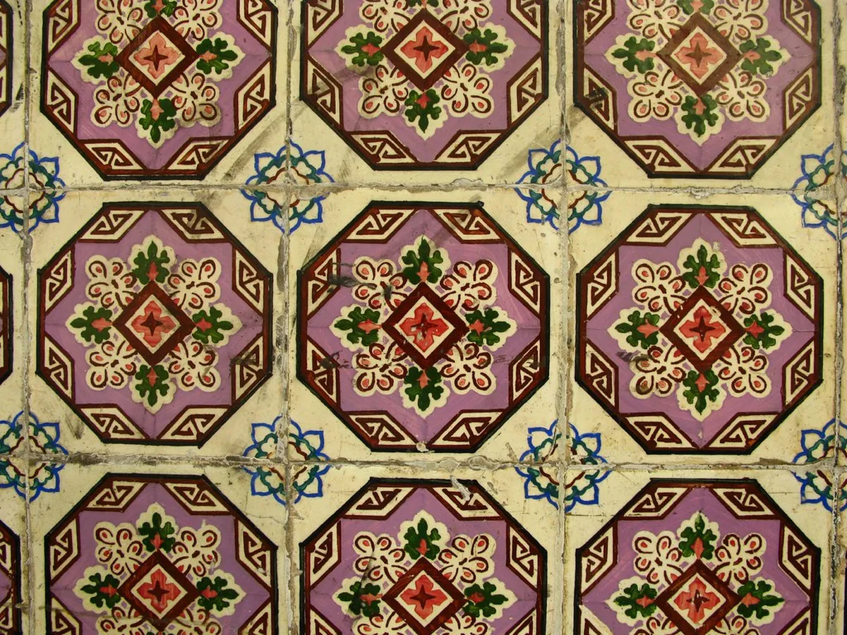 Handcrafted Lisbon azulejo ceramic tiles on display in an artisan craft workshop, showcasing traditional Portuguese painted tile art