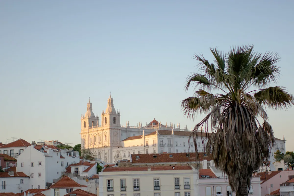 White baroque dome and twin towers of Basílica da Estrela rising above the Lisbon skyline