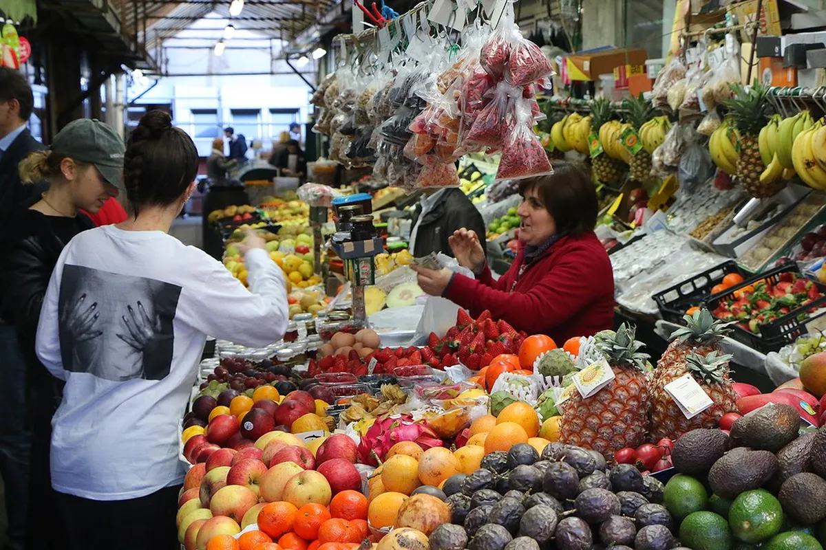 Porto market stalls brimming with fresh produce and local food vendors in a covered hall