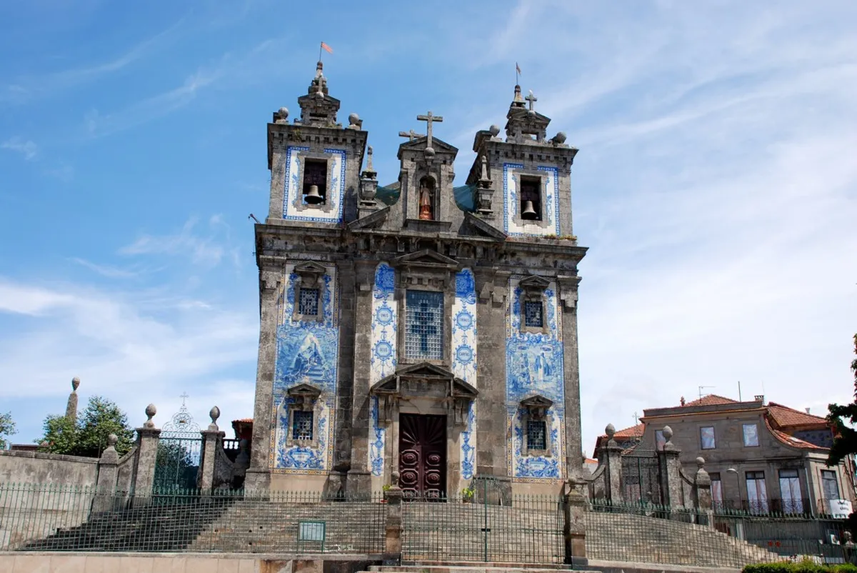 Porto's Igreja de Santo Ildefonso covered in blue and white azulejo tile panels, one of the most iconic attractions near Batalha Square