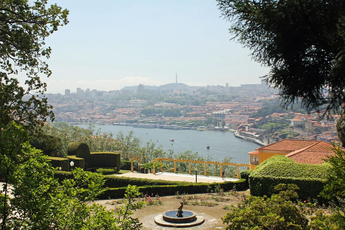 Lush terraced Gardens of Palácio de Cristal in Porto with the Douro River and Atlantic horizon visible in the distance