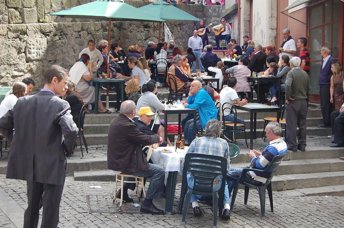 Intimate Porto Fado restaurant with candlelit tables set for an evening of traditional Portuguese music
