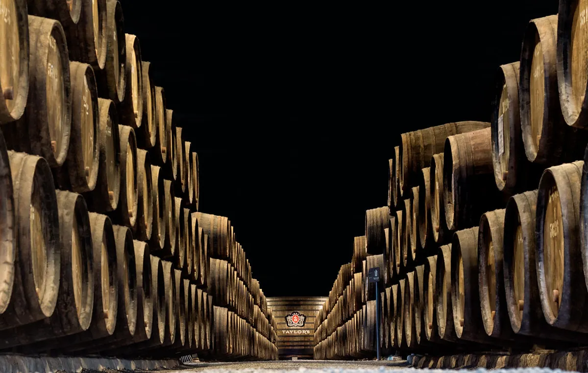 Porto Port wine cellar interior with wooden barrels lining the walls in a traditional lodge