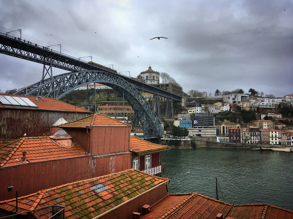 Dom Luis I Bridge and the colourful old houses of Porto's Ribeira neighborhood overlooking the Douro River