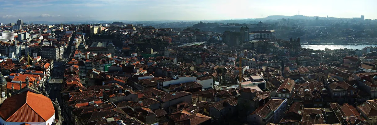 Panoramic rooftop view from Porto's Clérigos Tower overlooking terracotta rooftops and the Douro River