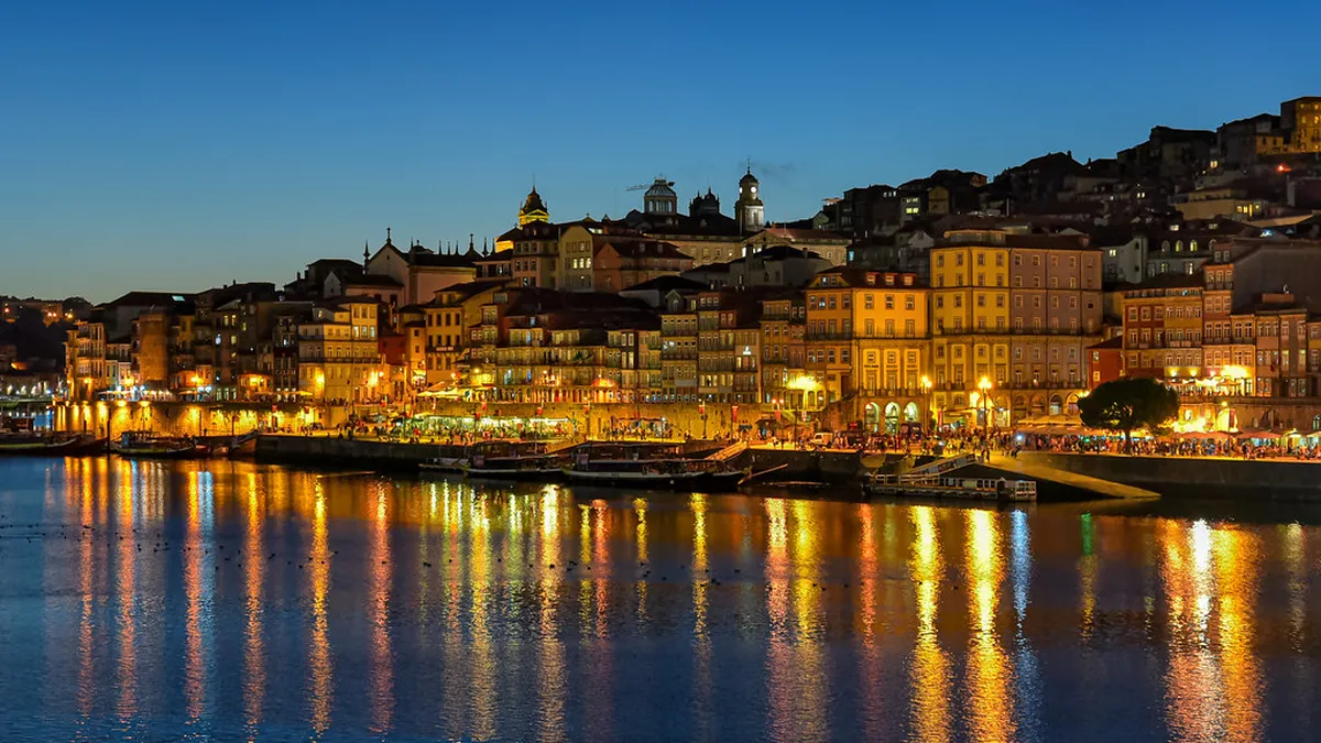 Colourful boats moored along Porto's Cais da Ribeira waterfront, the main departure point for Douro River cruises