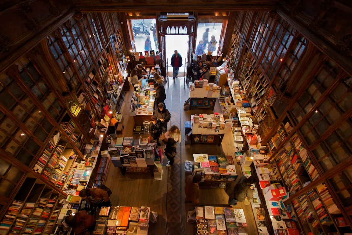 Interior staircase of Livraria Lello bookstore in Porto bathed in warm light