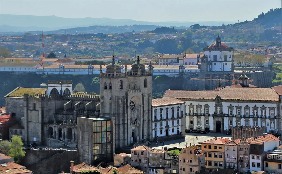 Porto Clérigos Tower rising above the Baroque church complex against a clear sky in the city centre