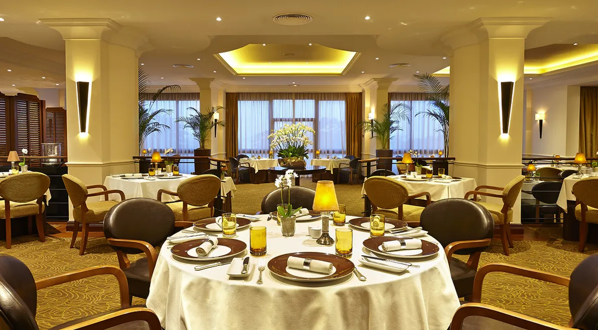 Elegant Porto fine dining restaurant interior with candlelit tables and stone walls in the historic Old City