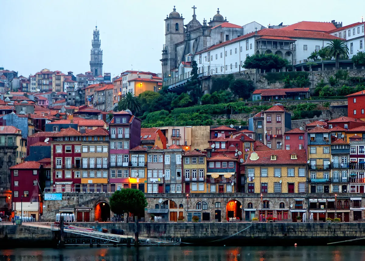 Porto Ribeira waterfront lined with colorful historic buildings reflected in the Douro River