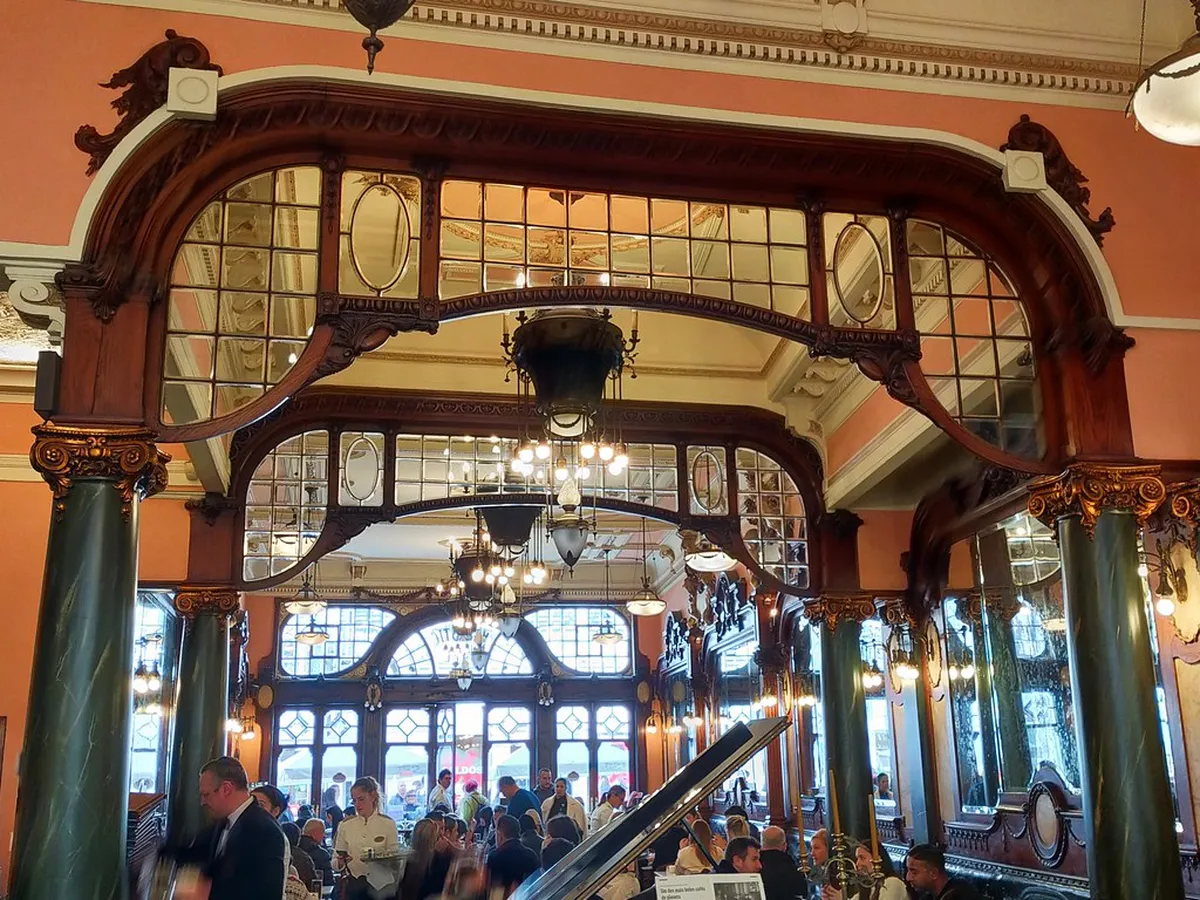Porto Rua de Santa Catarina pedestrian street lined with shopfronts and the ornate Art Nouveau facade of Café Majestic