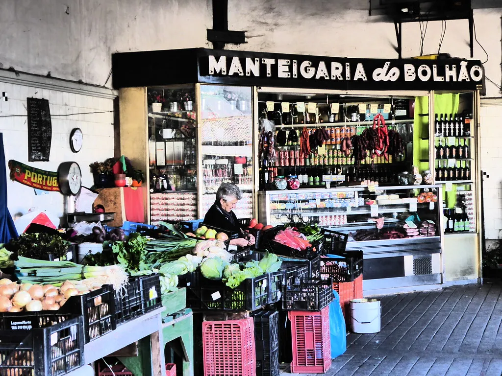Porto Mercado do Bolhão market hall with its iconic iron balconies and vendor stalls inside