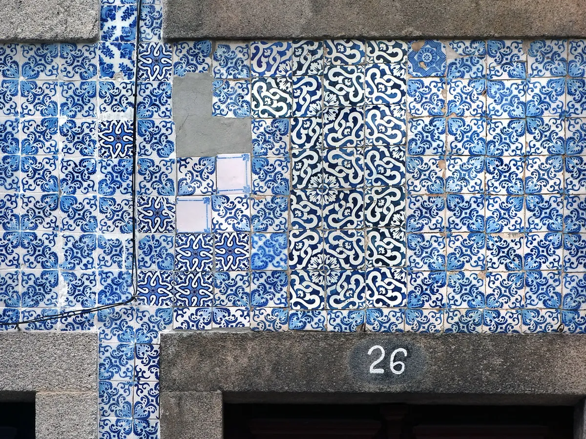 Handpainted Porto azulejos tiles displayed at a local souvenir shop, showcasing traditional Portuguese ceramic art