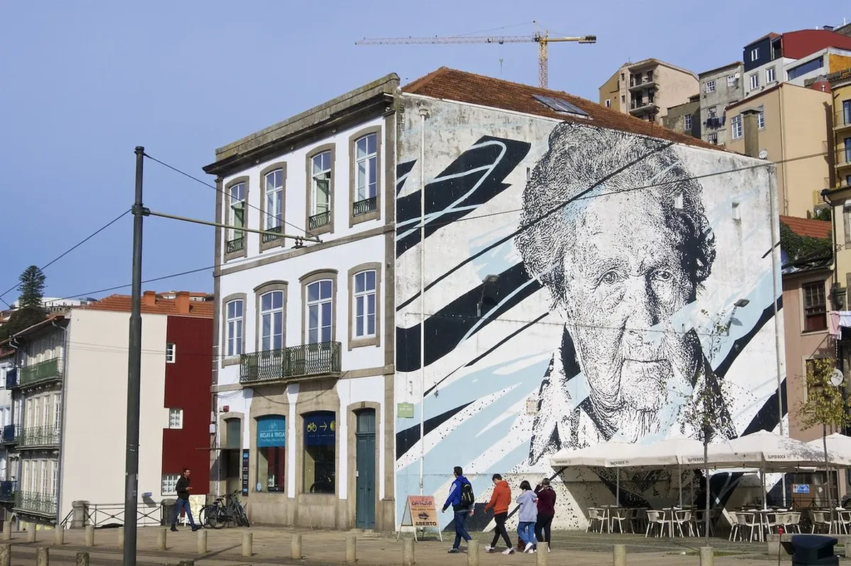 Colorful street art and historic tilework on the narrow winding lanes of Porto's Miragaia neighborhood