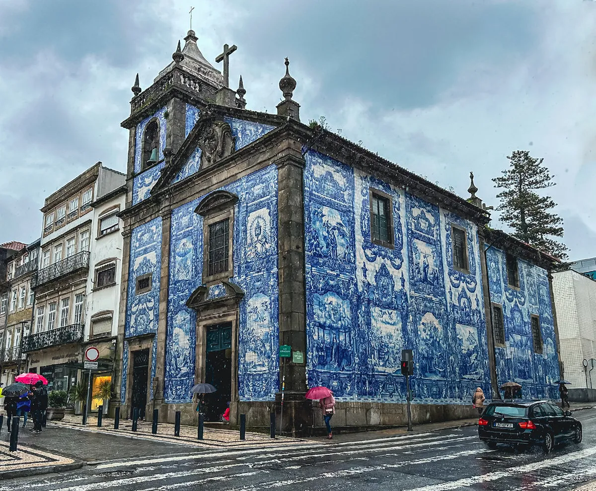 Porto's Capela das Almas facade entirely clad in vibrant blue-and-white azulejo tiles depicting scenes of saints