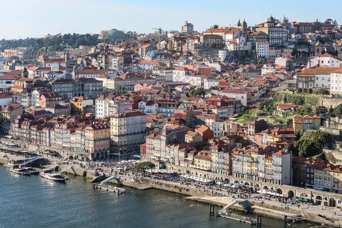 Porto Ribeira District colorful houses lining the Douro River waterfront on a sunny day