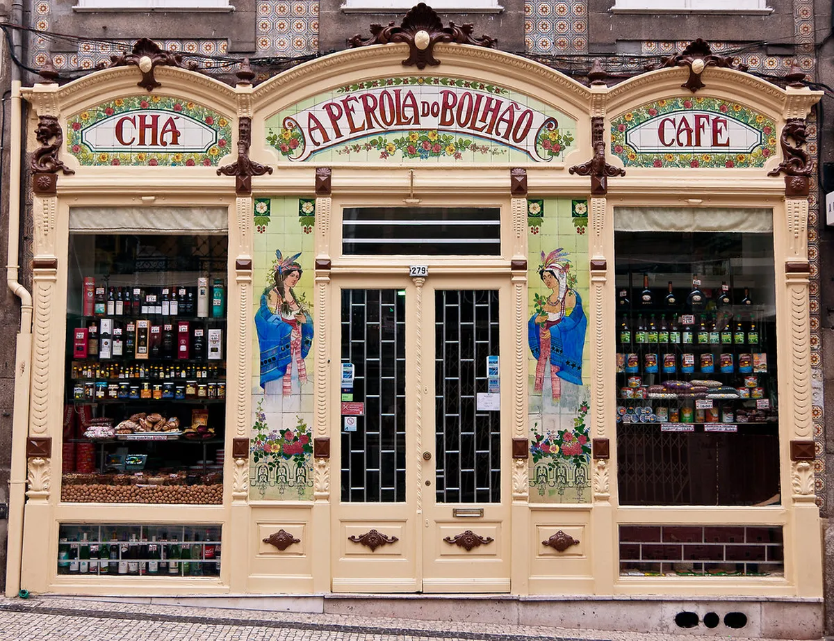 Porto cafe with elaborate Art Nouveau tilework and carved wooden details typical of the city's historic establishments