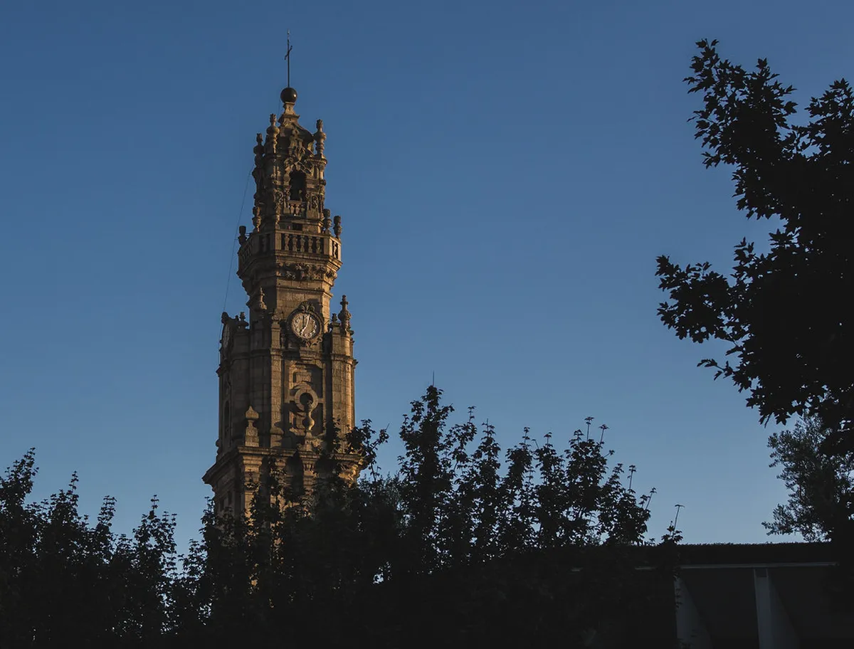 Porto Clérigos Tower baroque stone spire rising above the city rooftops against a clear sky