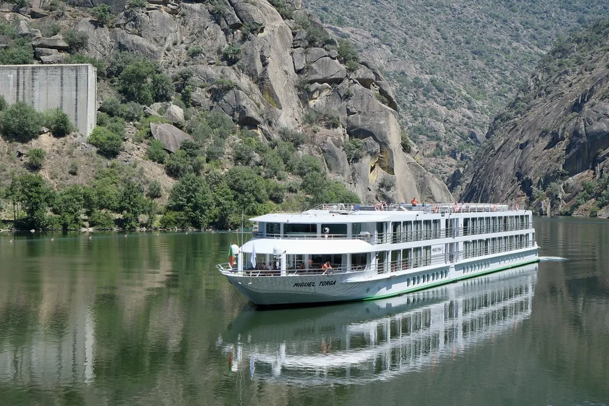 Porto Douro Valley terraced vineyards stretching along the river with traditional wine estates and scenic hillsides