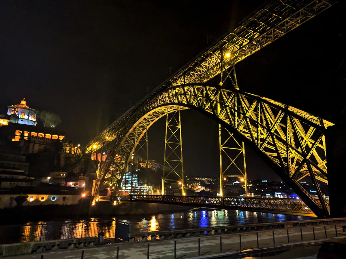 Porto Dom Luís I Bridge spanning the Douro River as seen from a cruise boat below