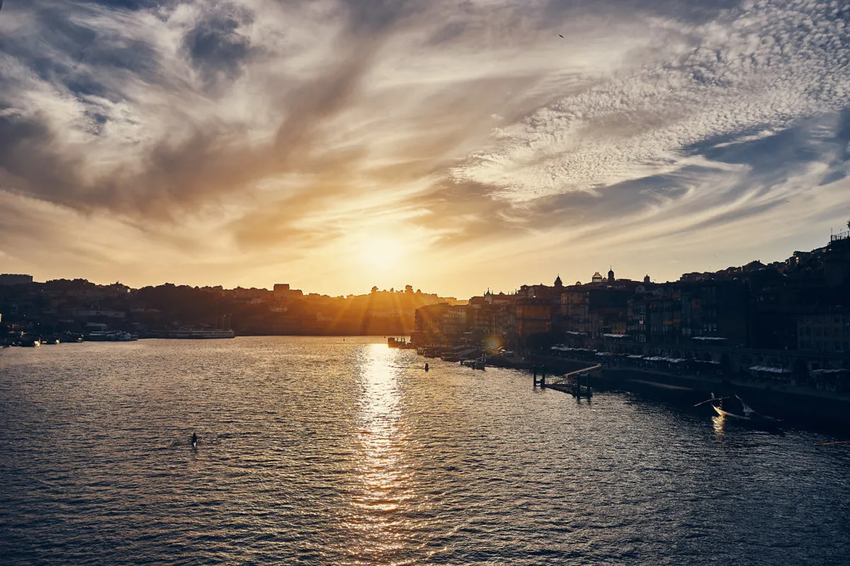Traditional Rabelo boats on the Douro River in Porto with the D. Luís I Bridge in the background