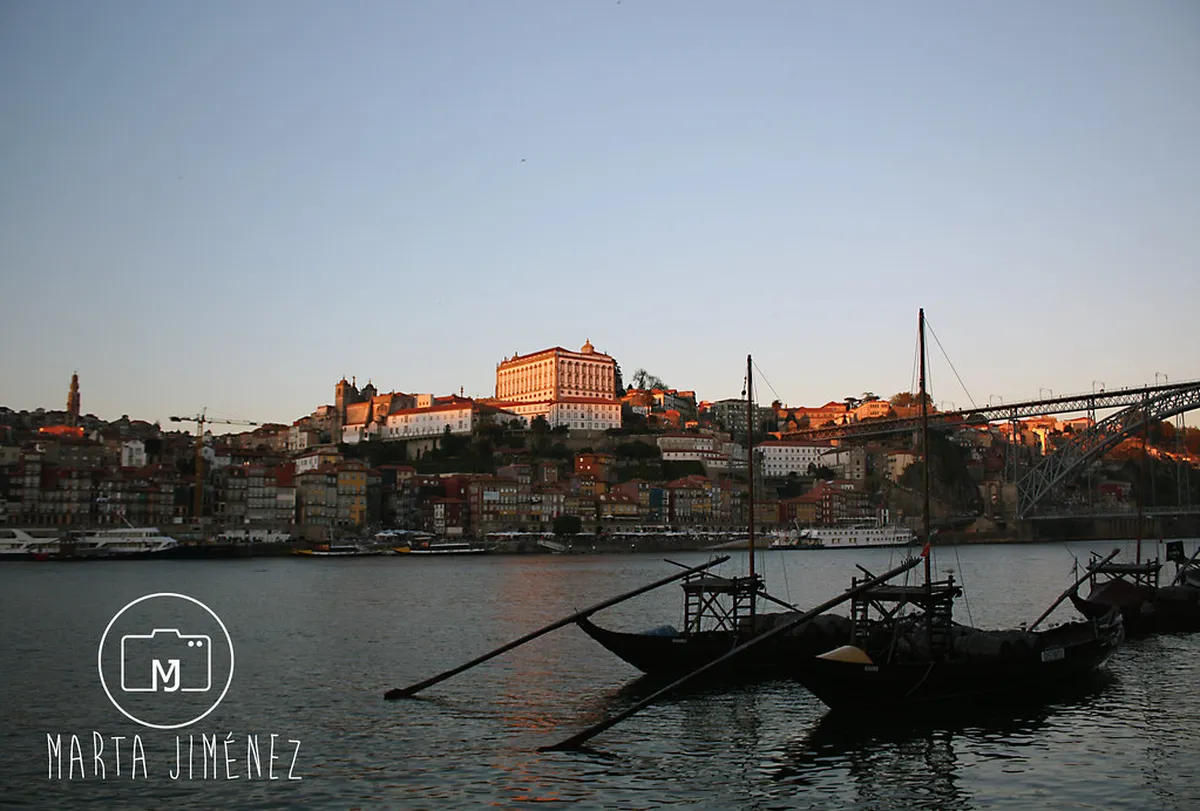 Colorful houses and boats lining the Porto Ribeira waterfront along the Douro River
